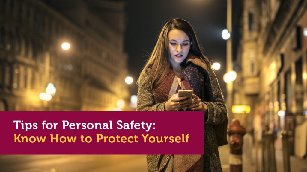 A women walking on the street looking at her mobile phone to search for personal safety for women advice